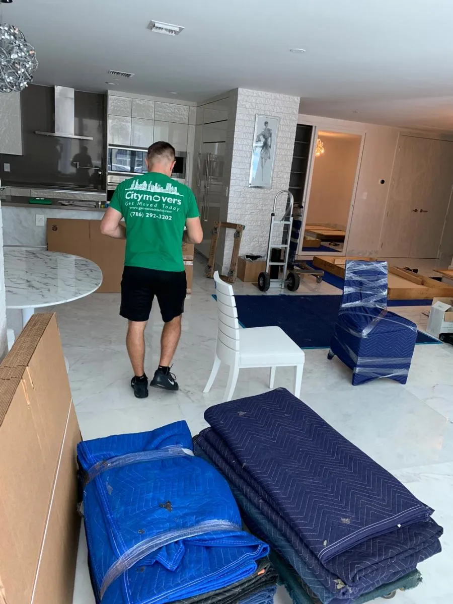 City Movers crew member walking through a condo with moving blankets